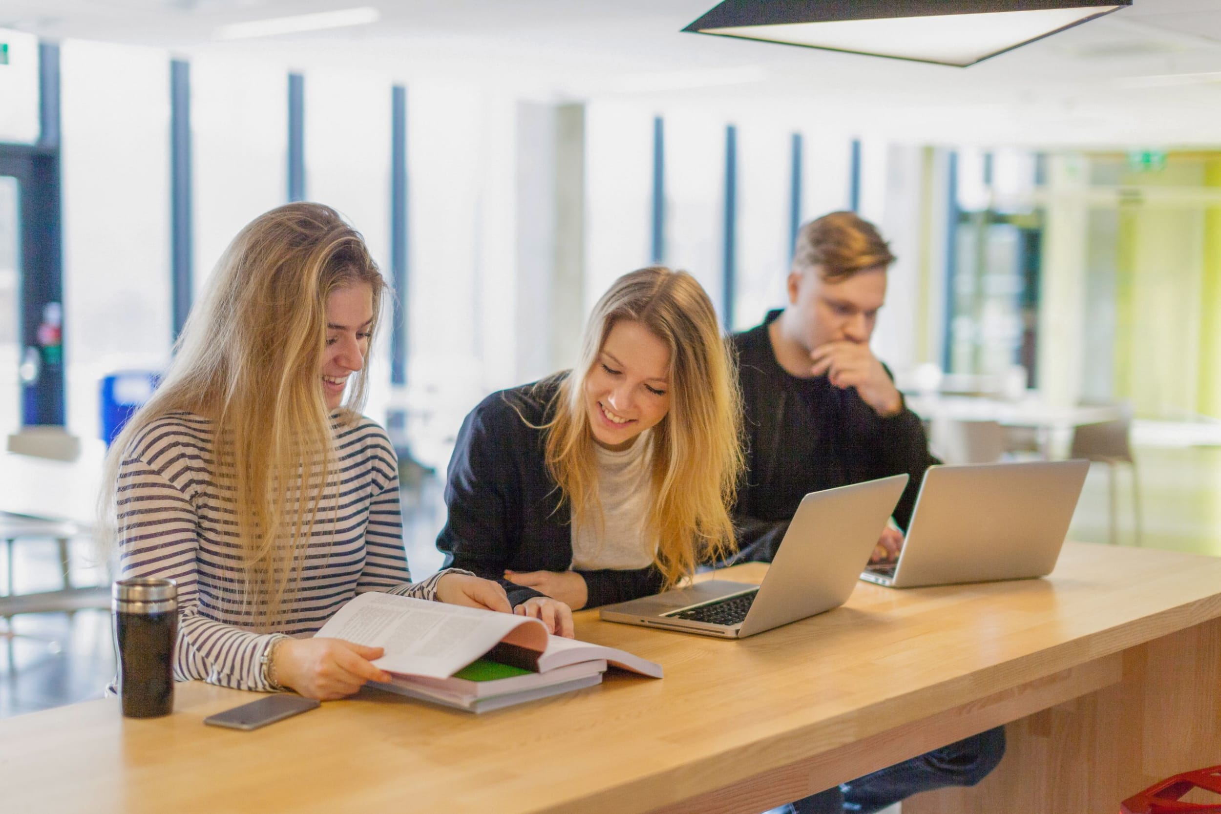Group of students sitting and working together